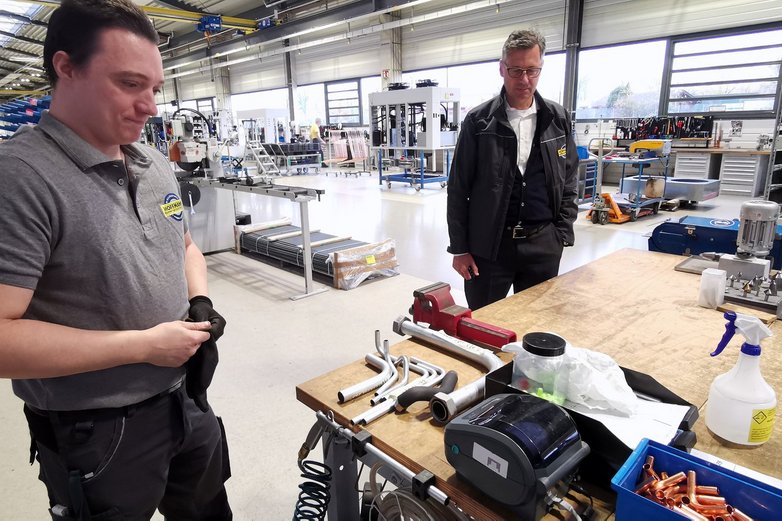 Sebastian Wagner von Hoffmann Lengede steht an einem Drucker. 