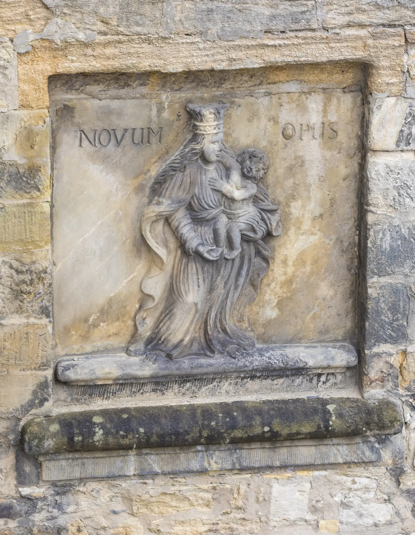 Ein altes Relief in das Novum Opus graviert ist.