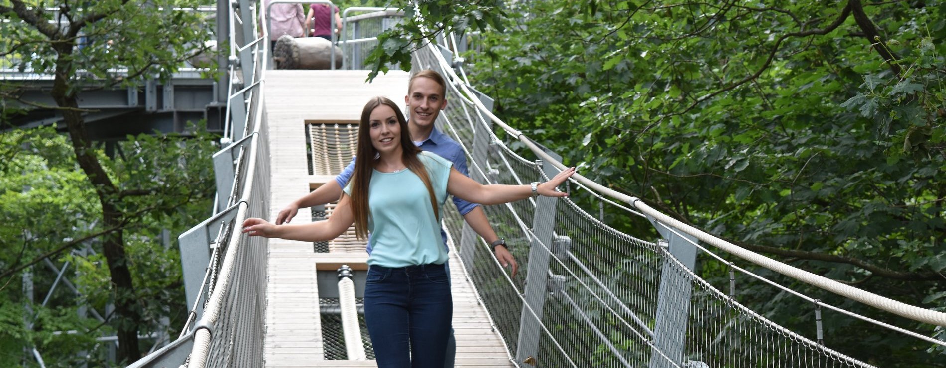 zwei junge Menschen gehen über eine Brücke