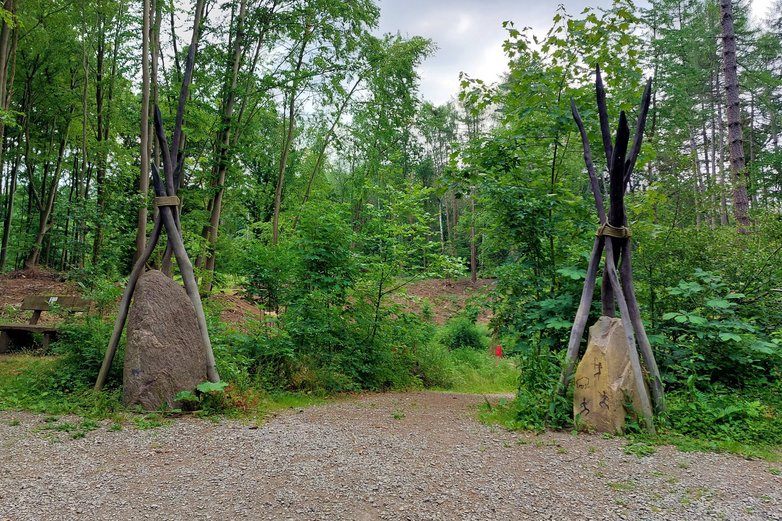 Der Taleingang, links und rechts Holz-Tipis.