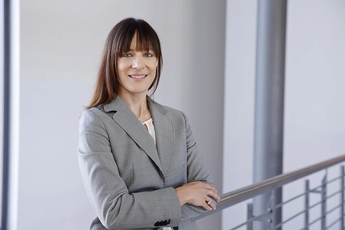 Eine Frau im grauen Blazer.