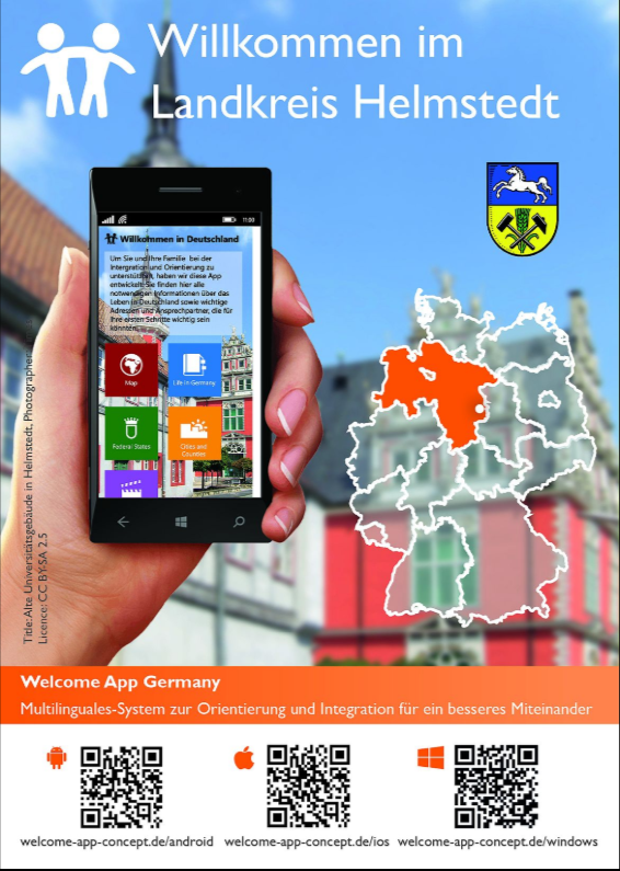 Eine Postkarte zeigt ein Smartphone mit der Welcome-App, im Hintergrund das Universitätsgebäude in Helmstedt.