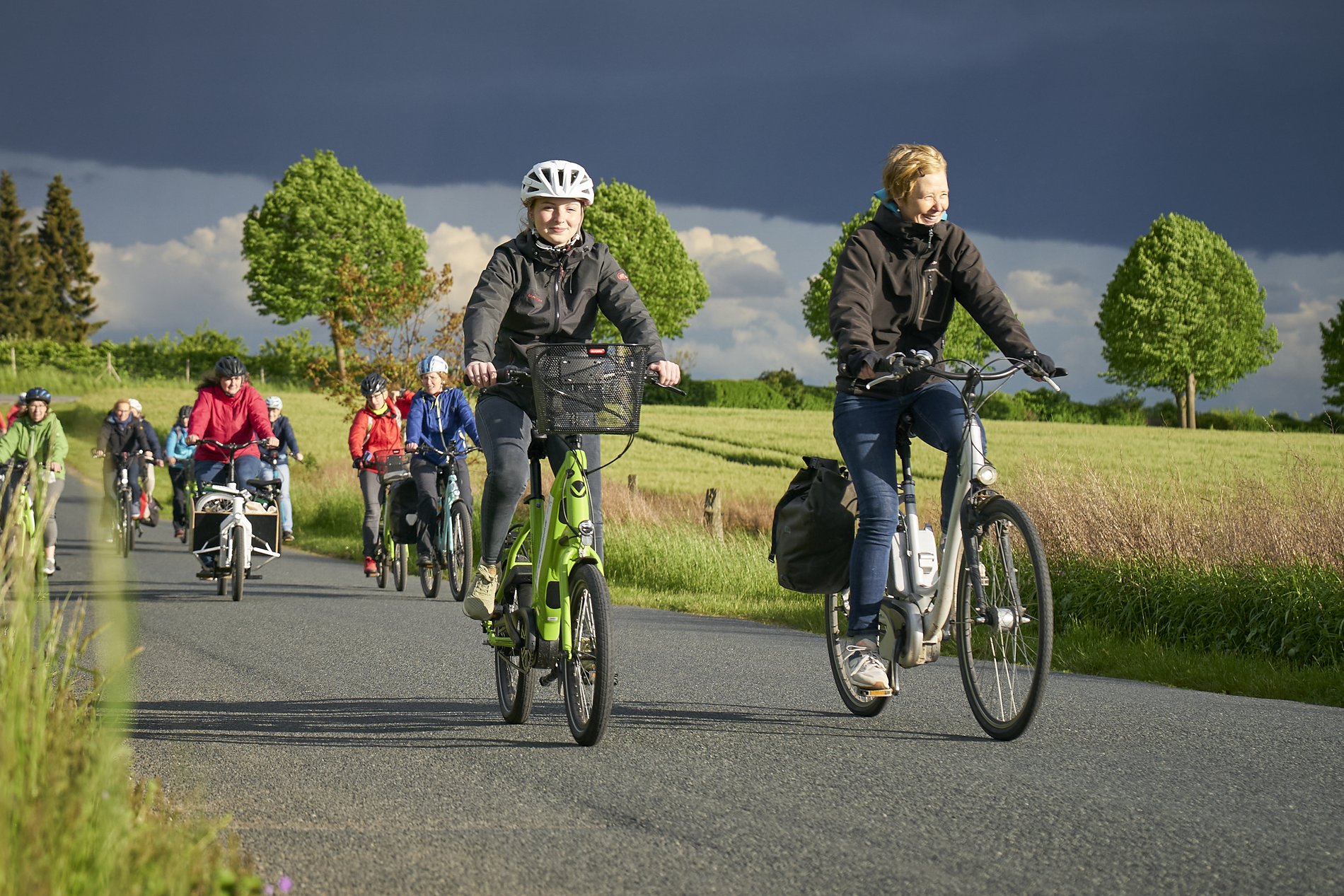 Eine Gruppe von Fahrradfahrern fährt auf einem Radweg über das Land.
